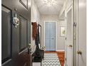 Inviting condo entryway with wood floors, coat rack, stylish decor, and a bright, welcoming atmosphere at 1280 W Peachtree Nw St # 3414, Atlanta, GA 30309