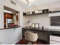 Efficient home office space with built-in shelving, stylish decor, and a convenient pass-through to kitchen at 1280 W Peachtree Nw St # 3414, Atlanta, GA 30309