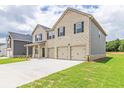 Two-story home with brick accents, three-car garage, and a spacious driveway at 204 Crabapple Rd, Mcdonough, GA 30253