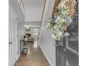 Light-filled entryway featuring hardwood floors and an elegant staircase leading to the second floor at 1039 Bramble Way, Grayson, GA 30017