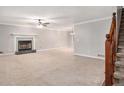 Spacious living room featuring a fireplace, neutral carpet, and staircase at 1083 Lake Dr, Snellville, GA 30039