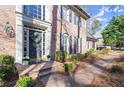 Close-up of a brick home entrance with a decorative door wreath and manicured front yard at 160 Wing Mill Rd, Sandy Springs, GA 30350