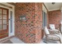 Welcoming front porch with seating area, brick accents, and classic columns at 1811 Mcconnell Rd, Grayson, GA 30017