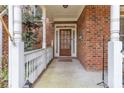 Cozy covered porch with brick accents and a traditional wood front door at 1811 Mcconnell Rd, Grayson, GA 30017