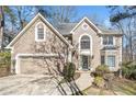 Charming two-story home with a well-maintained lawn and attached two-car garage at 217 Colonial Dr, Woodstock, GA 30189