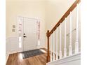 Inviting entryway featuring wood-look floors, a staircase, and a front door with decorative glass panels at 386 Creek Manor Way, Suwanee, GA 30024