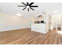 Spacious living area with light walls, ceiling fan, laminate flooring and easy access to the kitchen at 386 Creek Manor Way, Suwanee, GA 30024
