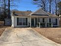 Inviting single-story home featuring green shutters, well-maintained landscaping, and a spacious driveway at 6163 Princeton Ave, Morrow, GA 30260
