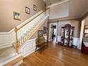 Inviting foyer with hardwood floors, staircase, and elegant decor at 6302 Manassas Nw Pass, Acworth, GA 30101