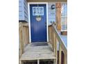 Close-up of a blue front door with a decorative wreath, framed by a white trim and a charming porch setting at 184 Cedarcrest Dr, Acworth, GA 30101