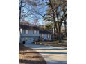 Charming two-story home with inviting curb appeal, set against a backdrop of mature trees and a neatly landscaped yard at 184 Cedarcrest Dr, Acworth, GA 30101