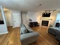 Cozy living room featuring a fireplace, mounted TV, and comfortable seating arrangement at 2115 Canyon Point Cir, Roswell, GA 30076