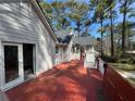 View of the house from the deck, showing the backyard with tall trees and blue sky at 98 Pace Dr, Hiram, GA 30141