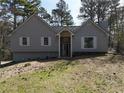Charming exterior view of the home with gray siding, shutters, and manicured front yard at 98 Pace Dr, Hiram, GA 30141