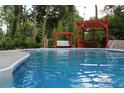 Refreshing outdoor pool featuring a poolside swing and a relaxing pergola at 98 Pace Dr, Hiram, GA 30141