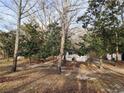 Quaint home surrounded by mature trees, offering a peaceful and private setting at 1619 Flowery Branch Rd, Auburn, GA 30011