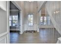 Bright foyer with hardwood floors and view to another room at 3540 Paddocks Pkwy, Suwanee, GA 30024