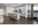 Modern kitchen featuring a large island with bar seating, stainless steel appliances, and hardwood floors at 921 Ambient Sw Way, Atlanta, GA 30331