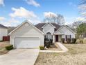 Well-maintained single-Gathering home with a two-car garage and beautiful landscaping at 4477 James Wade Dr, Snellville, GA 30039