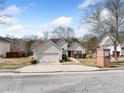 A single-Gathering home, with brick mailbox, featuring a well-manicured lawn and a two-car garage at 4477 James Wade Dr, Snellville, GA 30039