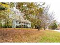 View of home with manicured lawn and mature trees at 476 Cody Ln, Douglasville, GA 30134