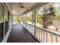 Covered porch with stained wood floors and white railings at 476 Cody Ln, Douglasville, GA 30134