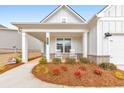 Inviting front porch with rocking chairs and beautiful landscaping enhances the curb appeal at 124 Redford Ln, Canton, GA 30115