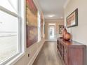 Hallway with wood floors, with natural light, and decorative art at 124 Redford Ln, Canton, GA 30115