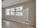 Open living room with new floors and natural light from a large window at 3783 Brookcrest Cir, Decatur, GA 30032