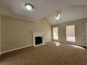 Inviting living room with a fireplace, ceiling fan, and bright windows at 916 Hunt Rd, Jonesboro, GA 30236