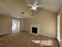 Spacious living room with fireplace, carpet, high ceilings, and natural light at 916 Hunt Rd, Jonesboro, GA 30236