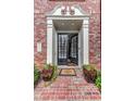Beautiful brick home entrance featuring a black, shuttered, double door, decorative plants, and welcome mat at 4206 Whitby Se Way # 15, Smyrna, GA 30080