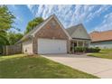 Charming single Gathering home with brick accents, manicured lawn, and a two-car garage at 239 Gilliam Ct, Locust Grove, GA 30248