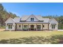 Charming home boasts a welcoming front porch, perfect for relaxing and enjoying the beautifully maintained lawn at 2925 Old Broadnax Mill Rd, Loganville, GA 30052