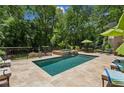 In-ground swimming pool and hot tub with paved surround and multiple seating and lounge areas at 750 Crest Valley Nw Dr, Sandy Springs, GA 30327