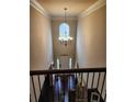 The home's grand foyer features soaring ceilings, a stunning chandelier, and a view of the front door at 1211 Chapel Estates Way, Dacula, GA 30019