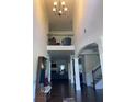 Spacious entryway with soaring ceilings, elegant staircase and dark hardwood flooring throughout main floor at 1211 Chapel Estates Way, Dacula, GA 30019