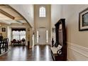 Grand foyer with soaring ceilings, beautiful hardwood floors, and a decorative bench at 1211 Chapel Estates Way, Dacula, GA 30019