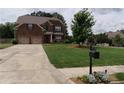 Beautiful brick home showcasing manicured front yard and a lengthy driveway leading to a two-car garage at 1211 Chapel Estates Way, Dacula, GA 30019