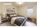 Comfortable bedroom features a window, side table, and large bed at 3064 Chastain Park Ne Ct, Atlanta, GA 30342