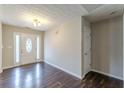 Bright foyer featuring wood floors, a textured ceiling, and a stylish front door with glass at 320 Creekside Trl, Covington, GA 30016