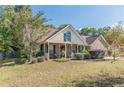 Inviting single-story home with a charming front porch and well-manicured lawn at 320 Creekside Trl, Covington, GA 30016