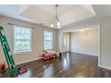 Open-concept living room with hardwood floors and a large window for natural light at 320 Creekside Trl, Covington, GA 30016