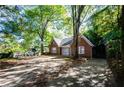A cozy brick home with a lush yard and mature trees offering shade and privacy at 17 Peachtree Ne Ave, Atlanta, GA 30305