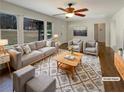 Bright living room with large windows, modern furniture, stylish rug, and ceiling fan at 1793 Witt Cir, Austell, GA 30168