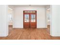 Elegant foyer displays hardwood floors and stylish double doors, creating a warm and inviting entrance at 529 Claude Scott Rd, Canton, GA 30115