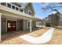 Inviting covered front porch with white columns and a striking wood double-door entrance at 529 Claude Scott Rd, Canton, GA 30115