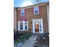 Inviting brick home showcasing colorful shutters, a bay window, well-kept landscaping and security system at 5012 Jenny Dr, Acworth, GA 30101