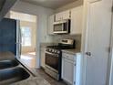 Well-equipped kitchen with stainless steel appliances, white cabinetry, tile backsplash, and plenty of natural light at 5012 Jenny Dr, Acworth, GA 30101