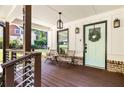 Inviting front porch with seating, stylish railing, wood flooring, brick accents, and eye-catching front door at 517 Daniel Ave, Decatur, GA 30032
